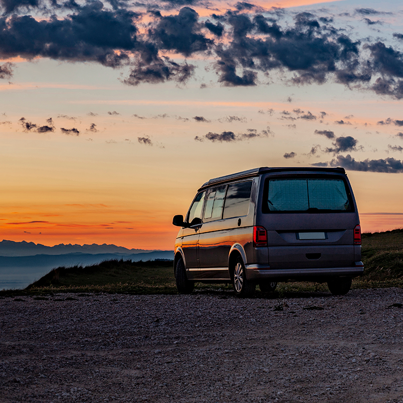 Campervan looking over mountains at sunset