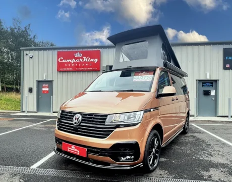 Copper Bronze Campervan with Poptop roof parked in front of CamperKing Scotland showroom