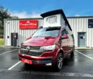 Fortana Red CamperKing campervan parked in front of CamperKing Scotland showroom with poptop roof up