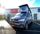 Pure Grey Highline LWB DSG CamperKing campervan parked in front of the CamperKing Scotland show room with the pop top roof up.