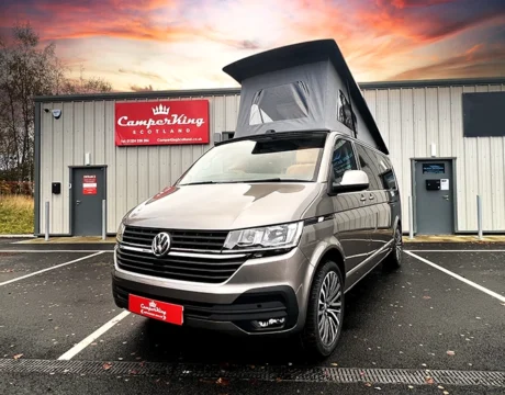 Mojave Beige Campervan parked in front of CamperKing Scotland Showroom with the pop top roof up.