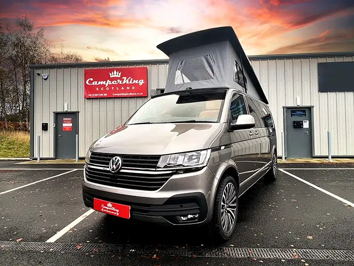 Mojave Beige Campervan parked in front of CamperKing Scotland Showroom with the pop top roof up.